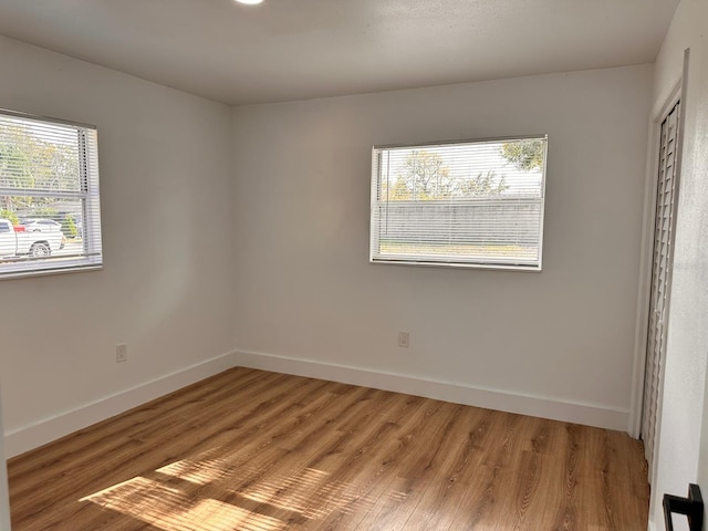 empty room with hardwood / wood-style floors