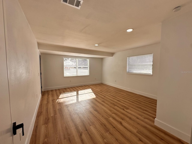 unfurnished room featuring hardwood / wood-style flooring