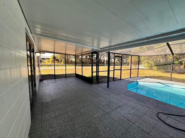 view of pool featuring glass enclosure and a patio area