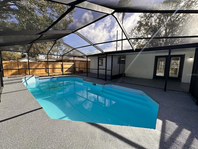 view of swimming pool with a patio and glass enclosure