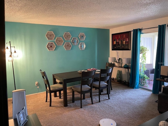 carpeted dining space with a textured ceiling