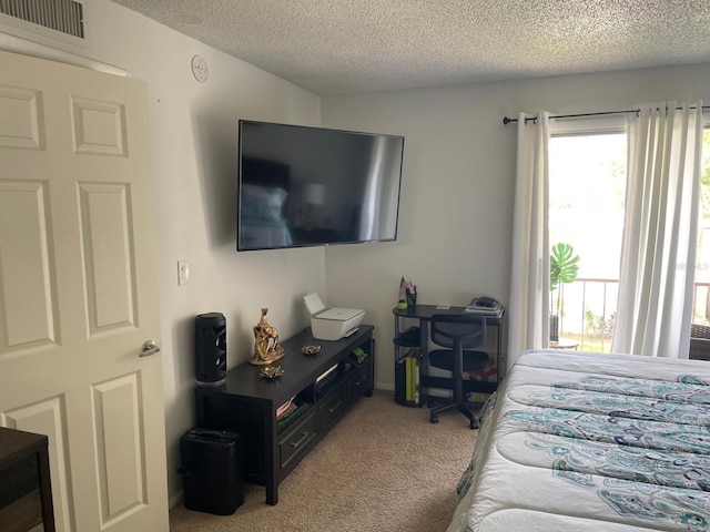 bedroom with carpet flooring and a textured ceiling