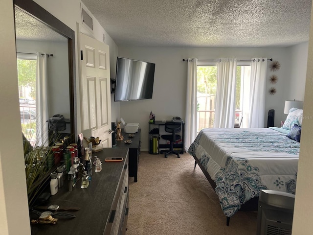 carpeted bedroom featuring a textured ceiling and multiple windows