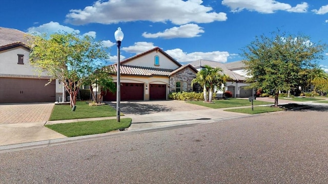 view of front of house with a garage and a front lawn