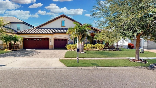 view of front of home with a garage and a front lawn