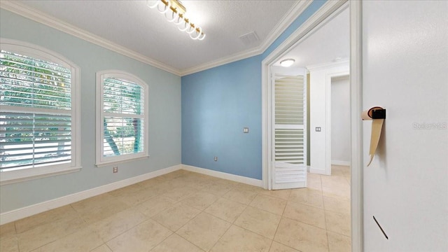 tiled empty room with a textured ceiling and crown molding