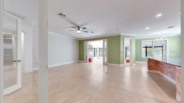 unfurnished room featuring ceiling fan, light tile patterned flooring, and ornamental molding