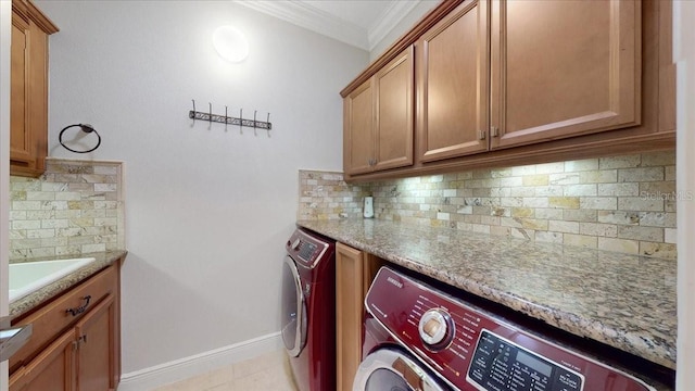 washroom with sink, cabinets, crown molding, washer and clothes dryer, and light tile patterned flooring