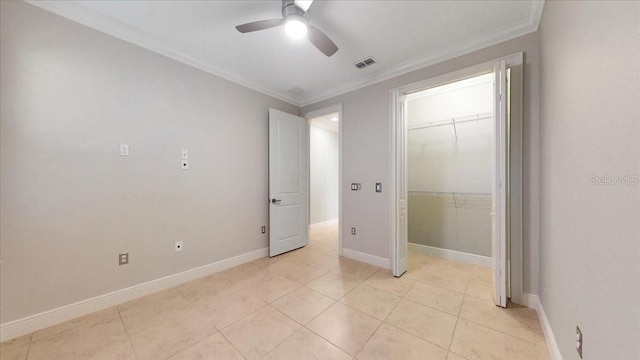 unfurnished bedroom featuring ceiling fan, light tile patterned floors, crown molding, and a closet