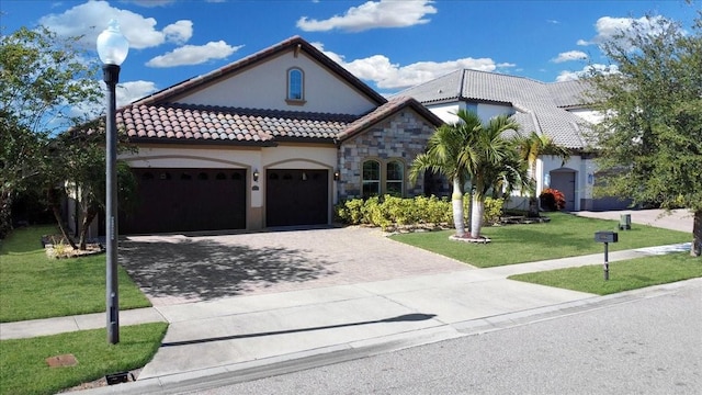 view of front of home featuring a garage and a front lawn