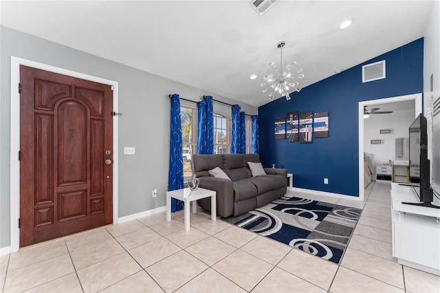 tiled living room with ceiling fan with notable chandelier and vaulted ceiling