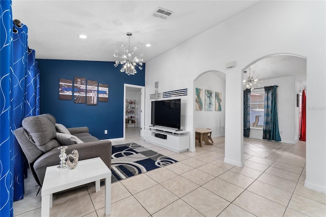 tiled living room with a chandelier and vaulted ceiling