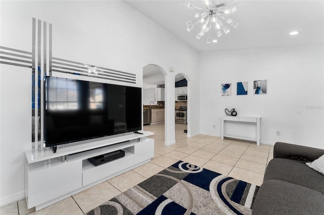 tiled living room with a chandelier and high vaulted ceiling