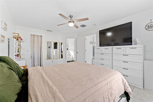 tiled bedroom featuring ceiling fan