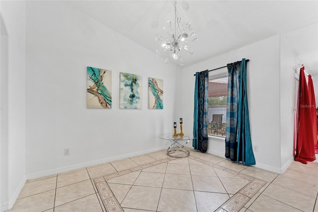 unfurnished room featuring light tile patterned floors, an inviting chandelier, and lofted ceiling