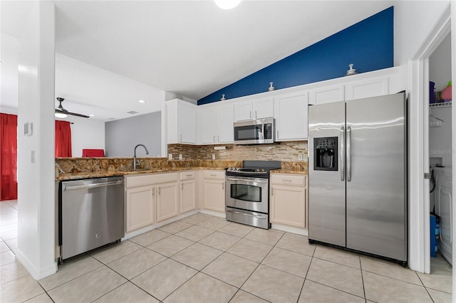 kitchen featuring light stone countertops, stainless steel appliances, ceiling fan, white cabinets, and light tile patterned flooring