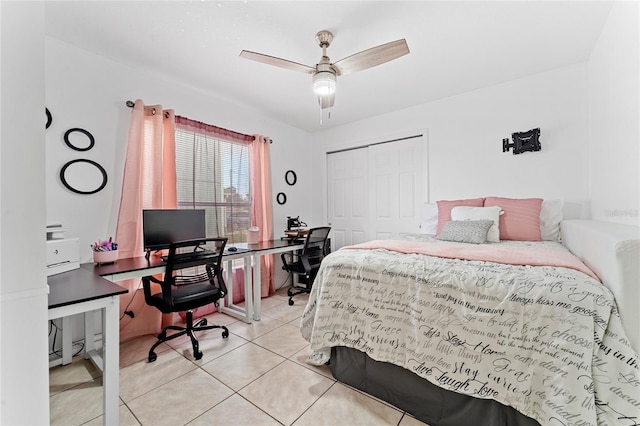 bedroom with ceiling fan, a closet, and light tile patterned floors