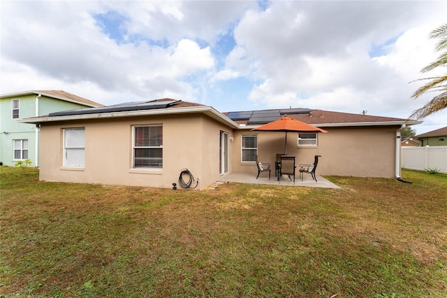 rear view of house featuring a yard and a patio