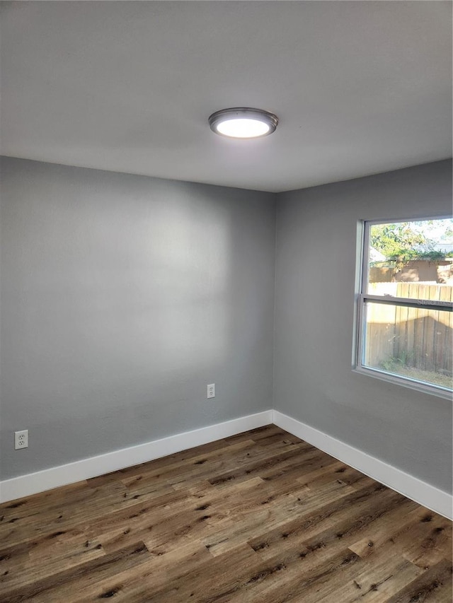 spare room featuring dark hardwood / wood-style flooring