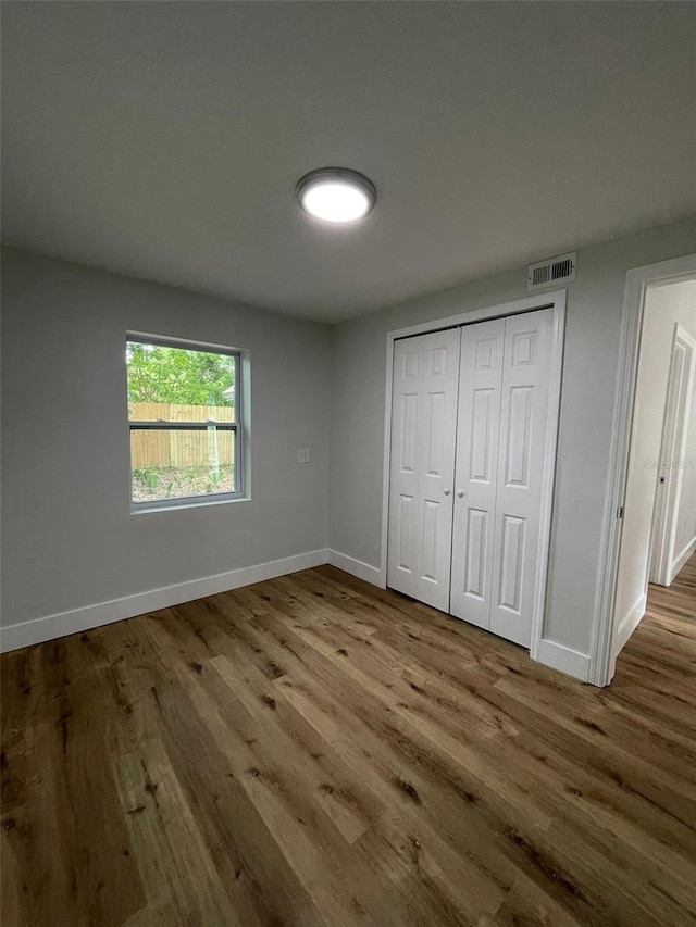 unfurnished bedroom with a closet and light wood-type flooring