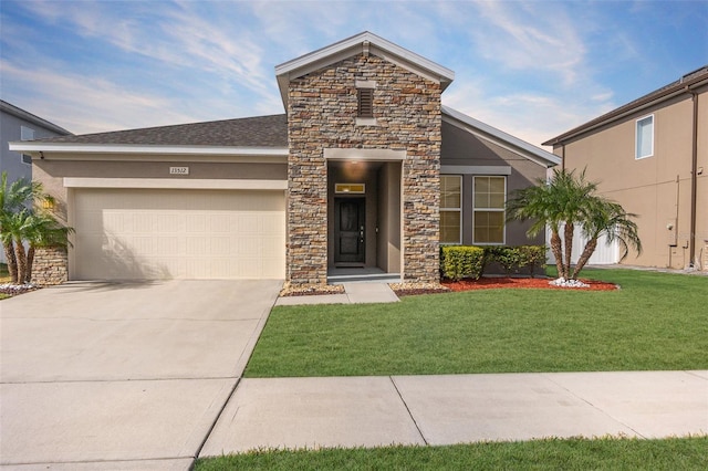 view of front of home featuring a front lawn and a garage