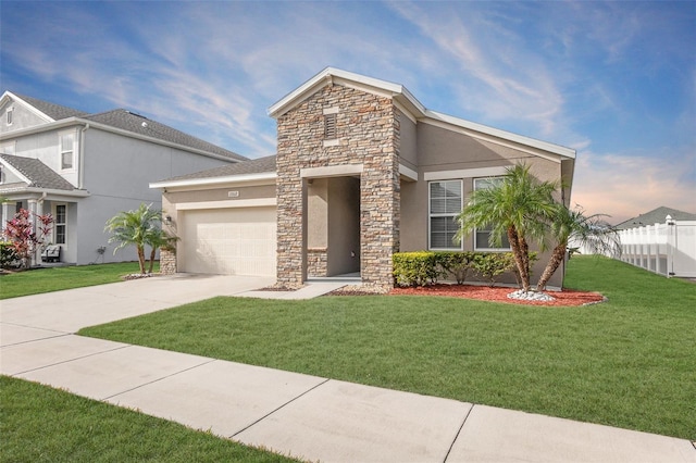 view of front of property featuring a yard and a garage