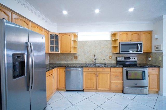 kitchen featuring ornamental molding, sink, appliances with stainless steel finishes, and dark stone counters