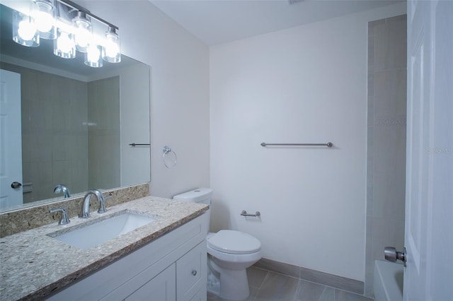 bathroom featuring tile patterned flooring, vanity, and toilet