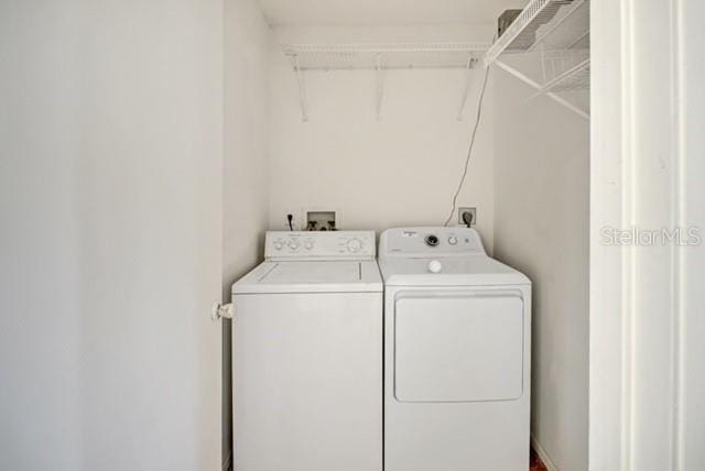 washroom with washing machine and clothes dryer