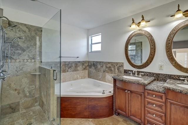 bathroom with vanity and separate shower and tub