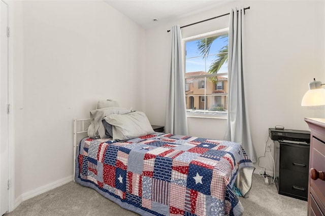 bedroom featuring light colored carpet