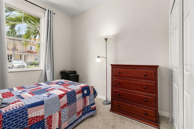 carpeted bedroom with a closet