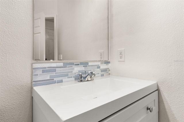 bathroom featuring decorative backsplash and vanity