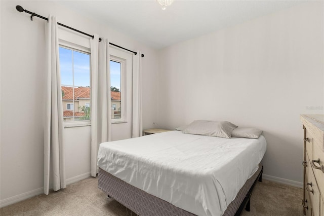 bedroom featuring light colored carpet