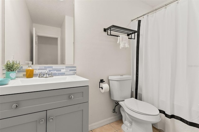 bathroom featuring tasteful backsplash, tile patterned floors, a textured ceiling, toilet, and vanity