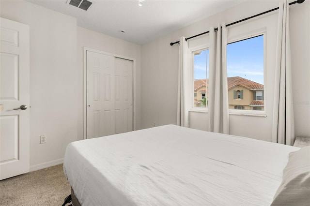 carpeted bedroom featuring a closet