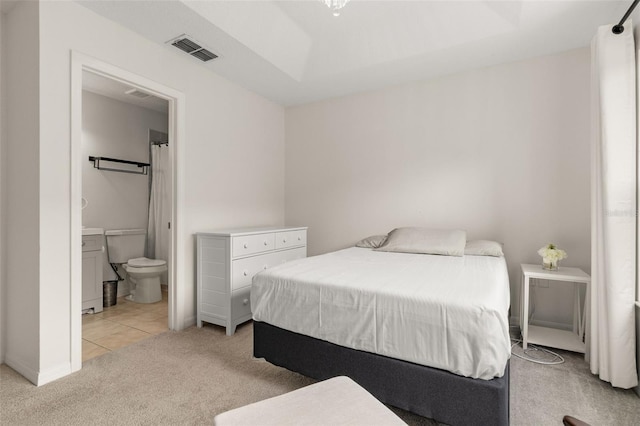 carpeted bedroom with ensuite bath