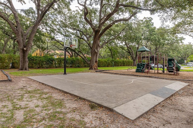 view of sport court with a playground and a lawn