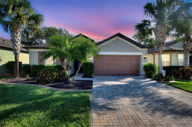 ranch-style home with a yard and a garage