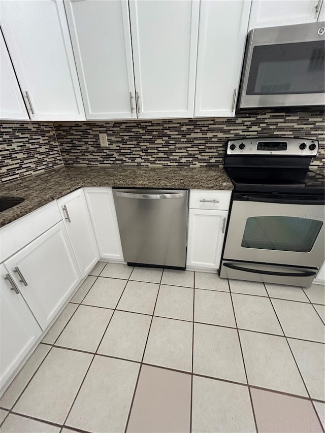 kitchen featuring appliances with stainless steel finishes, tasteful backsplash, and white cabinetry