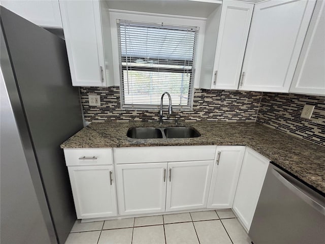 kitchen featuring appliances with stainless steel finishes, white cabinetry, and sink