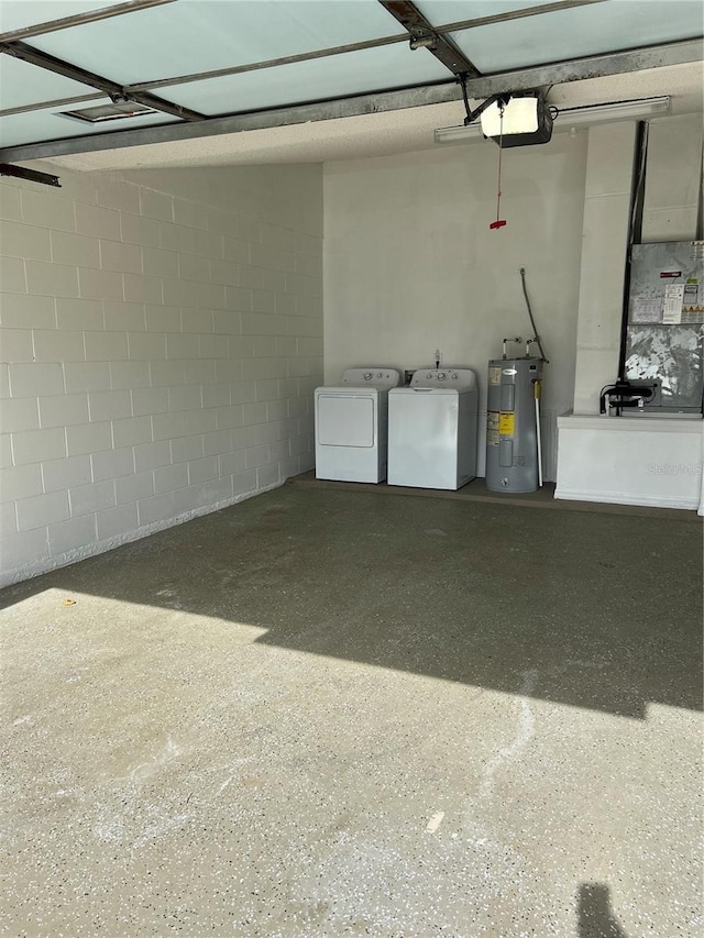 garage featuring electric water heater and separate washer and dryer