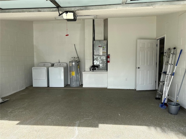 garage with separate washer and dryer, a garage door opener, and water heater