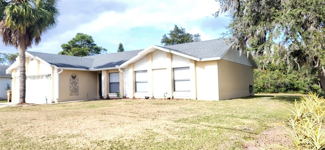 view of front of property with a front lawn and a garage