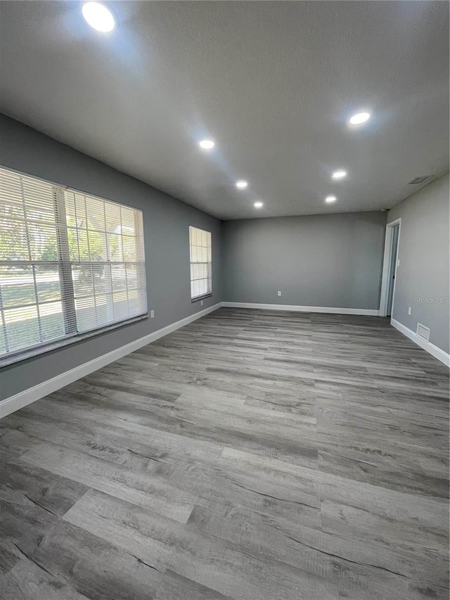 spare room featuring hardwood / wood-style flooring and a textured ceiling