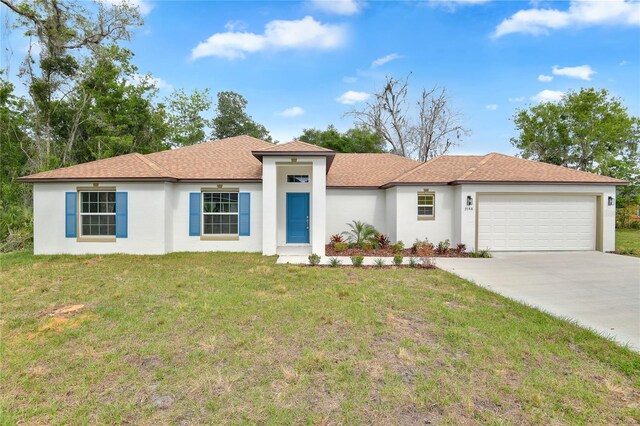 314A Dagama Ct, Kissimmee, FL 34758 - view of front facade with an attached garage, driveway, stucco siding, and a front lawn