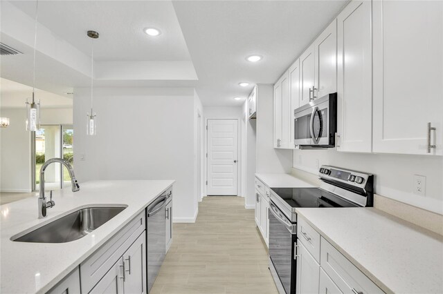 314A Dagama Ct, Kissimmee, FL 34758 - kitchen featuring stainless steel appliances, light stone countertops, white cabinetry, and a sink
