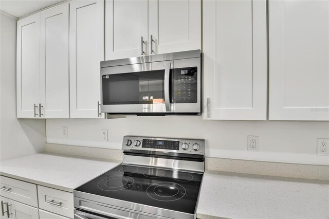 314A Dagama Ct, Kissimmee, FL 34758 - kitchen featuring stainless steel appliances, light stone countertops, and white cabinetry