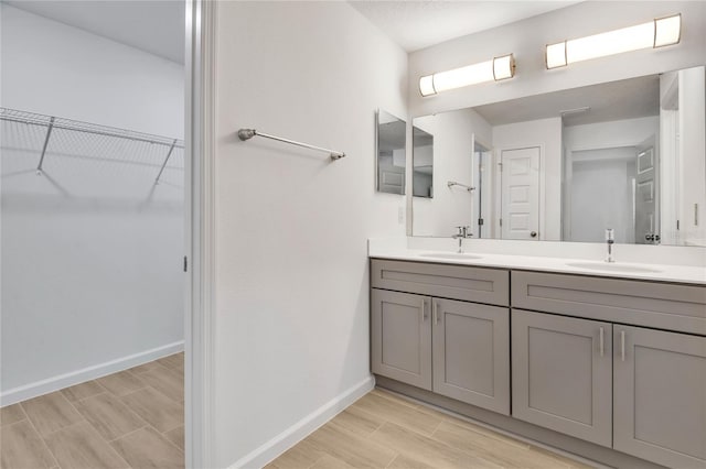 314A Dagama Ct, Kissimmee, FL 34758 - full bathroom with a walk in closet, double vanity, baseboards, and a sink