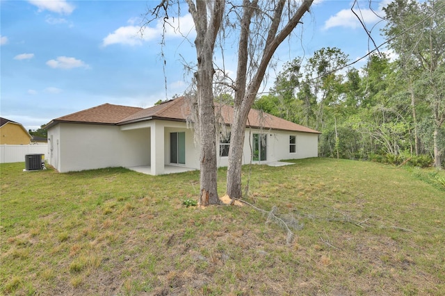 314A Dagama Ct, Kissimmee, FL 34758 - back of property with central air condition unit, stucco siding, a patio area, fence, and a lawn